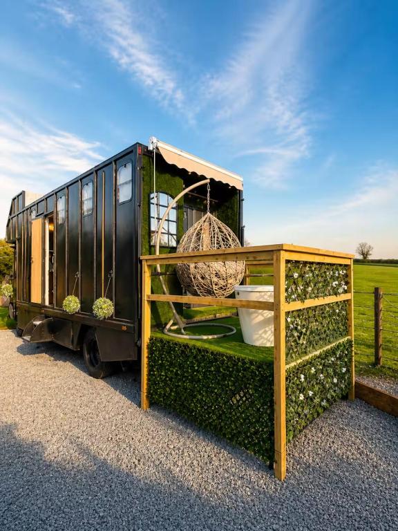 a train car with a cage and a table at The Stallion in Sturminster Newton