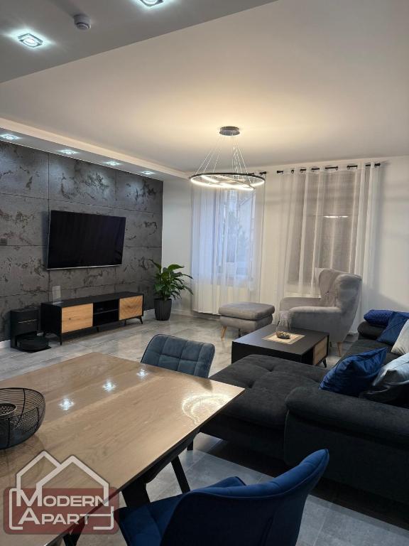 a living room with a couch and a table at Modern Apart in Wałbrzych