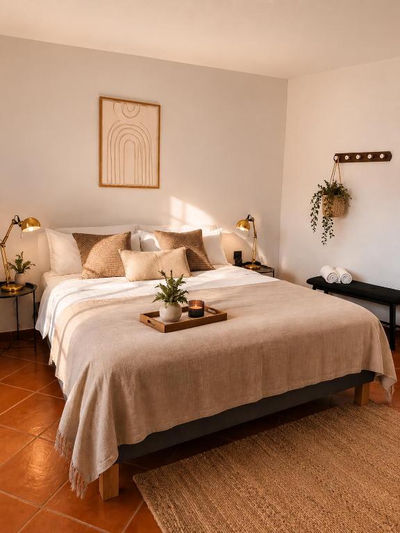 a bedroom with a large bed with a tray on it at Refúgio No16 Ocean Air & Rooftop Flair in Albufeira