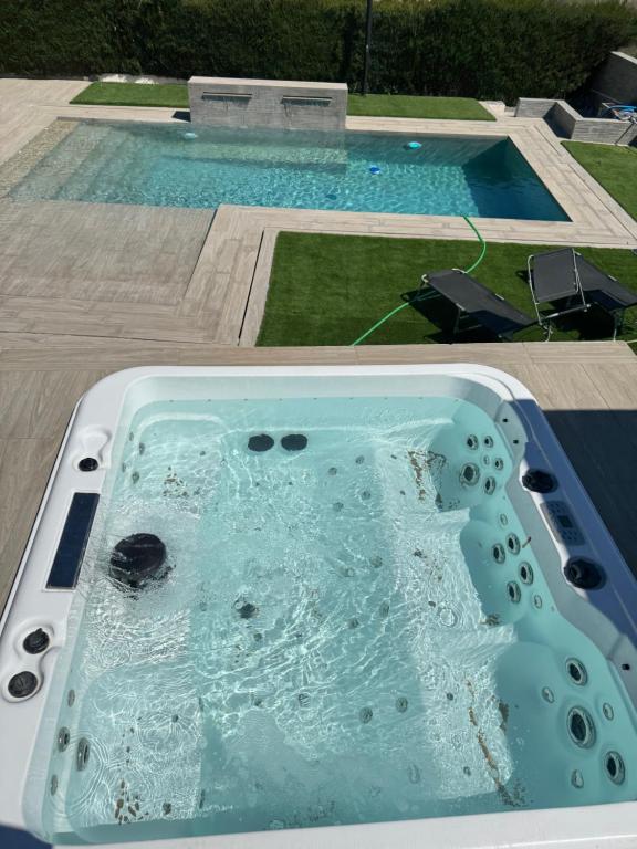 a bath tub filled with water in a swimming pool at Villa Baena in Granada