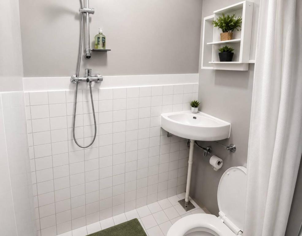 a bathroom with a shower and a toilet and a sink at Stay Central Malta in San Ġwann