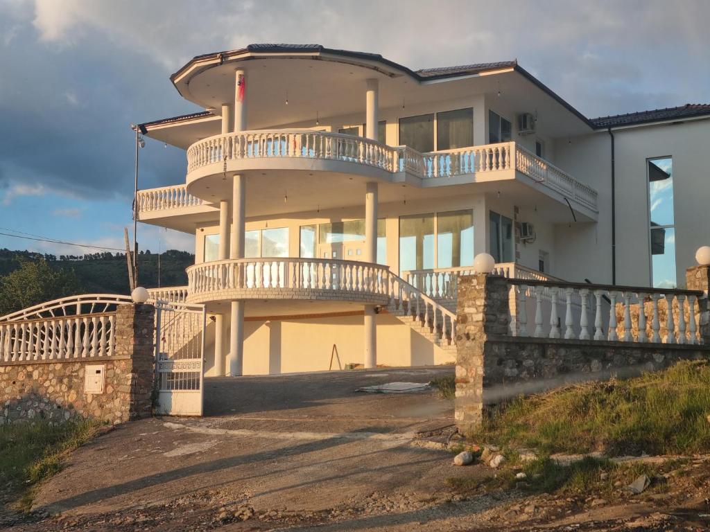 a large house with a balcony and a staircase at Kalanar villa in Elbasan