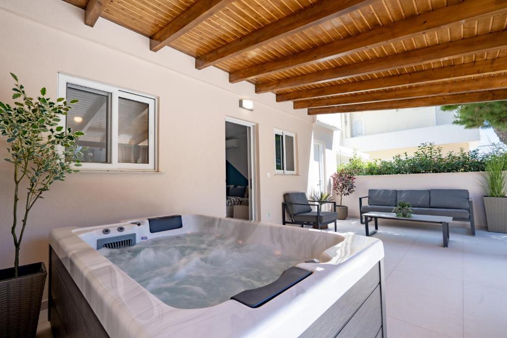 a hot tub in the middle of a patio at Artemis Boutique House in Artemida
