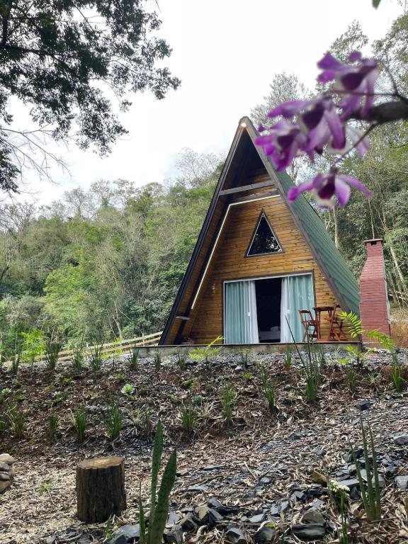 a small house with a window on a hill at Chalé Refúgio das Águas in Ituporanga