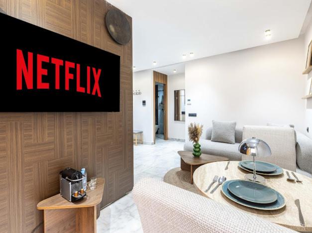 a living room with a netflix sign on a wall at Arena Maarif 41 in Maarif