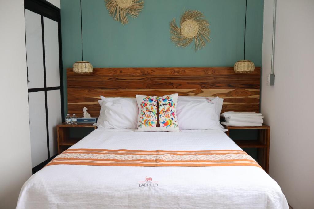 a bedroom with a white bed with blue walls at Habitación arroqueño in Oaxaca City