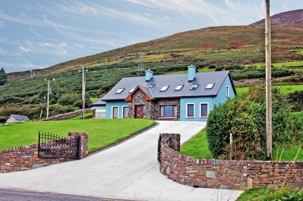 a blue house on a hill with a driveway at 4 Bed in Inch oc-i190 in Anascaul