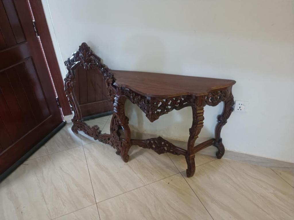 a wooden table sitting on top of a floor at Call it a home in Rawalpindi