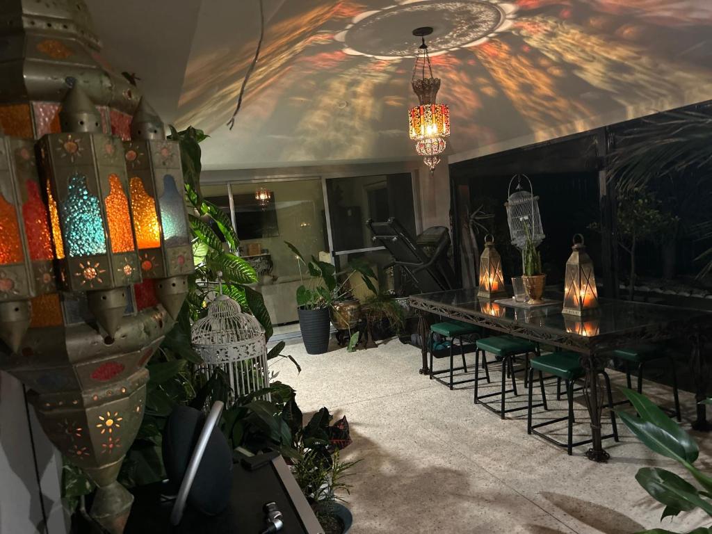 a room filled with plants and a table with chairs at Whitfords Garden Retreat in Perth