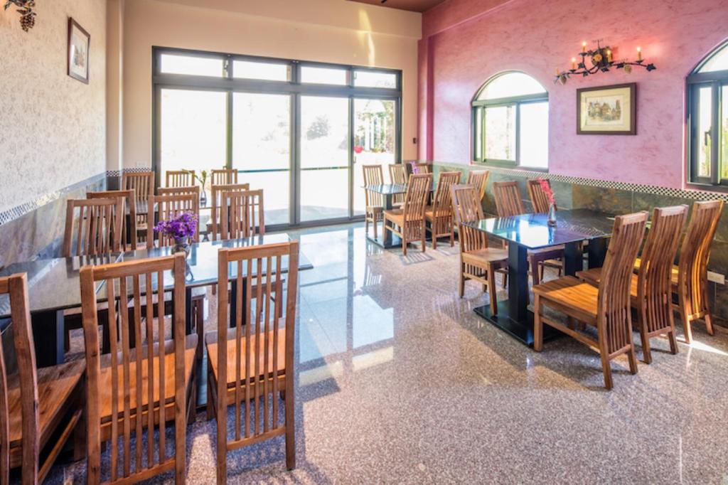 a dining room with wooden tables and chairs at Zum Adler Castle B&amp;B in Jiaoxi