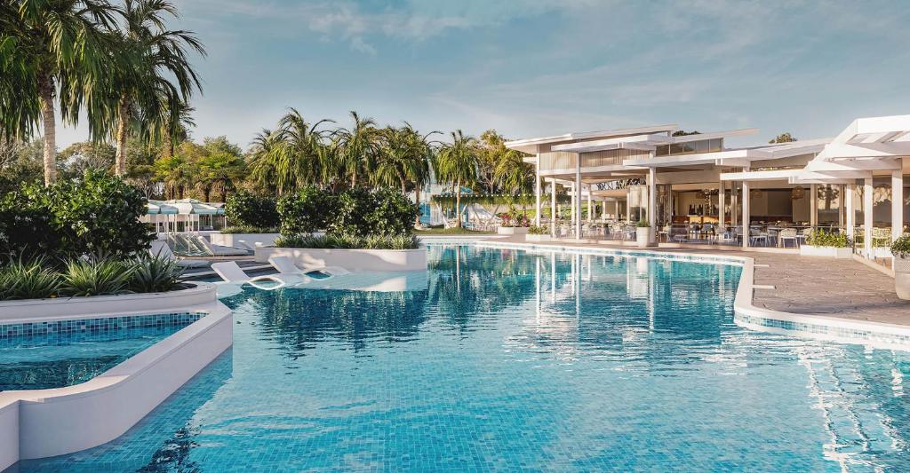 a swimming pool in front of a villa at Trentham Waters Resort in Gol Gol