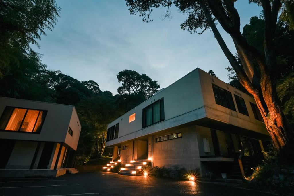 a house with lights on the side of it at Boscage Kariya in Yugawara