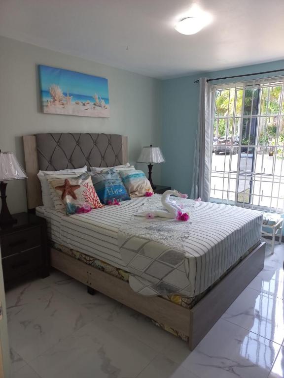 a bedroom with a large bed in a room at Sea Castles La Vue in Montego Bay