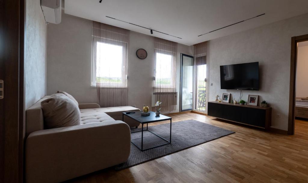 a living room with a couch and a tv at Apartment N22 in Leštane