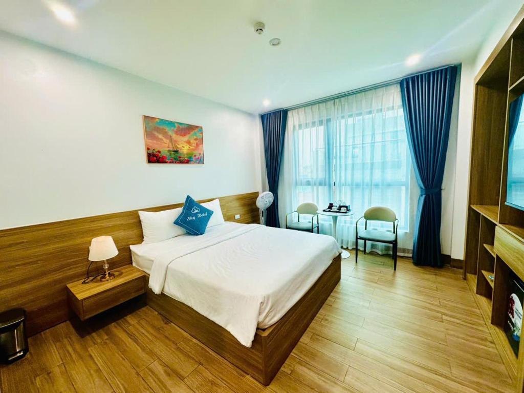 a hotel room with a bed and a table at Sky Hotel in Ninh Binh