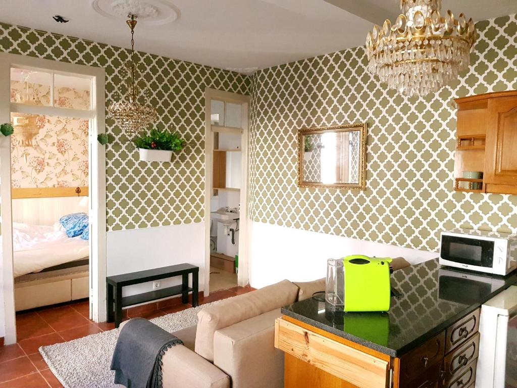 a kitchen and living room with a chandelier at Cozy Sintra Townhouse in Sintra