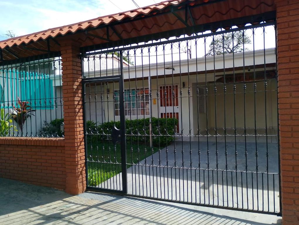 a metal gate in a brick building at Sergio's House in Cartago
