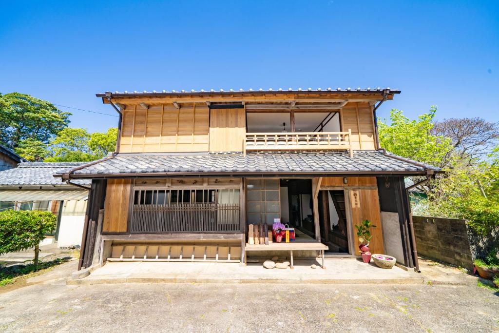 a house with a bench in front of it at 青木邸 in Tokushima