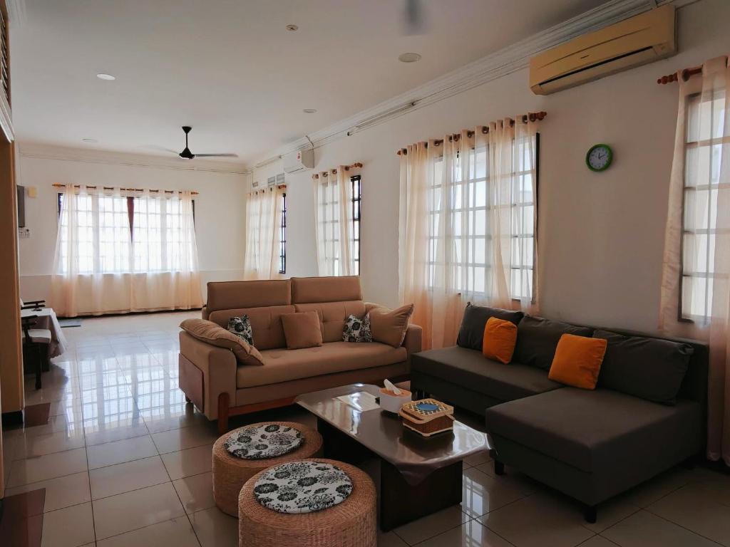 a living room with a couch and a table at Sentul KL Private Cozy Bungalow Homestay - Free Parking & Wifi in Kuala Lumpur