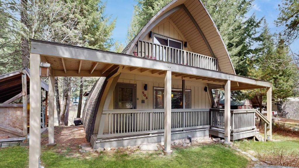 a house with a wrap around porch with a wrap around deck at Cozy A-Frame Cabin in Downtown McCall in McCall