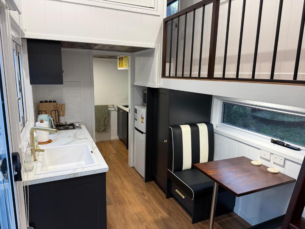 a small kitchen with a sink and a table at Big Tiny Medlow in Medlow Bath