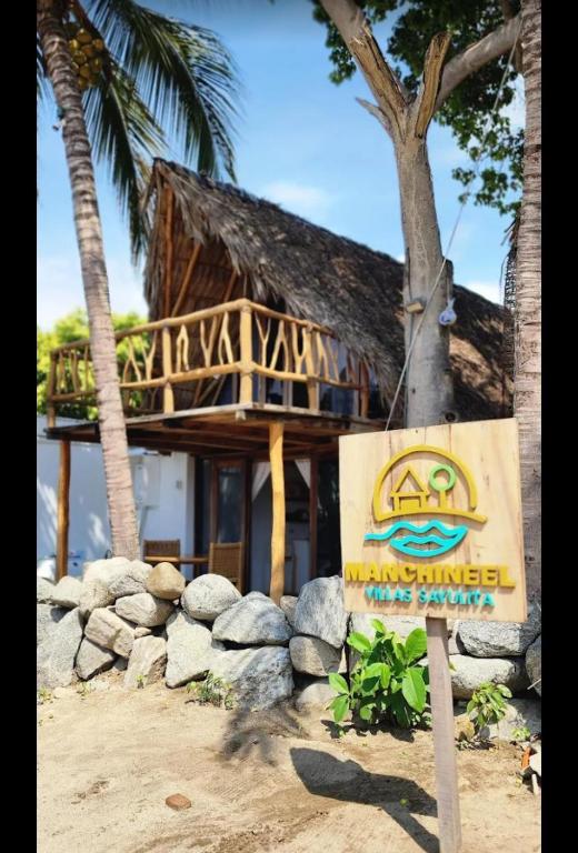 a sign in front of a building on a beach at Villas Manchineel in Sayulita