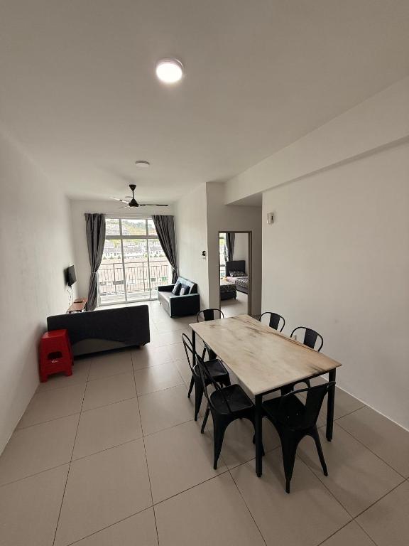 a living room with a wooden table and chairs at Peace Homestay 2 in Brinchang