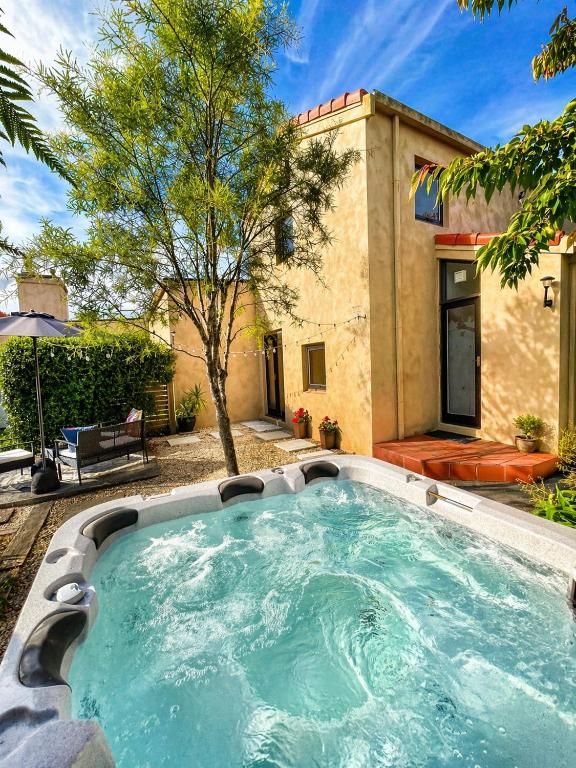a swimming pool in front of a house at Eirene Retreat - Quiet Riverside Escape in Upper Hutt