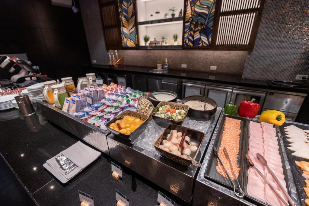 A chilled buffet counter offers fruit, dairy, cereal and sliced fish.