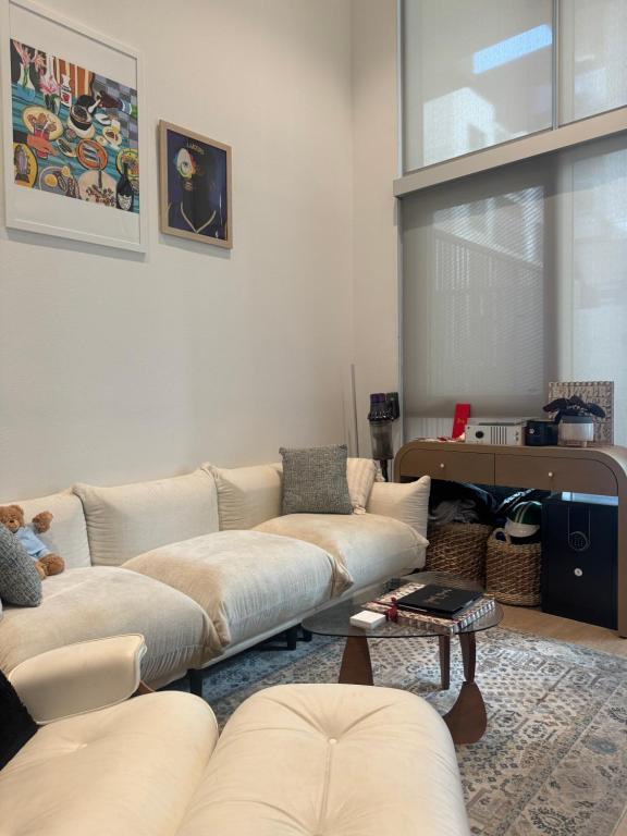 a living room with two couches and a table at Luxury Loft 1BR Steps Away from Santa Monica Pier in Los Angeles