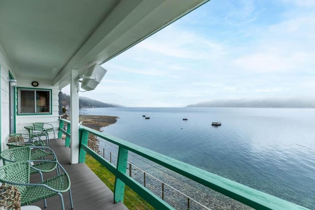 a balcony with a view of the water at Oyster Oasis in Tahuya
