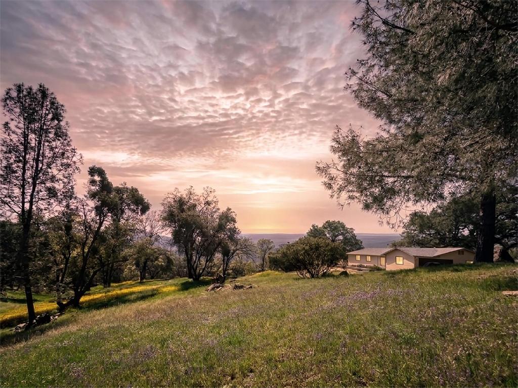 a house on a hill with a field and trees at Sunset Site Boulder Bliss HotTub by Casa Oso in Ahwahnee
