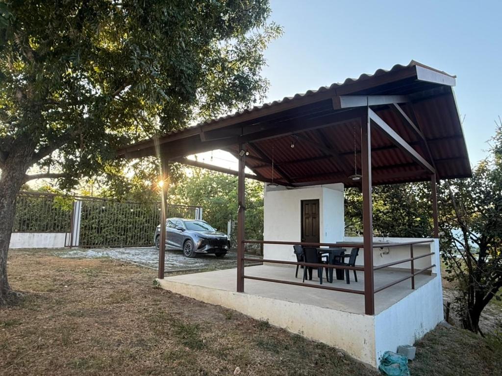 a pavilion with a table and chairs in a yard at Villa Rosita in San Carlos
