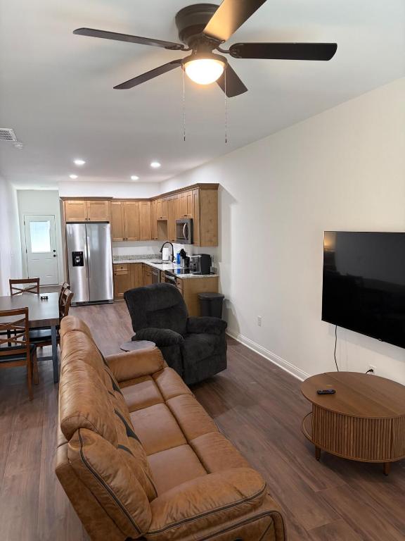 a living room with a couch and a flat screen tv at Brand new condo right off the interstate in Berea