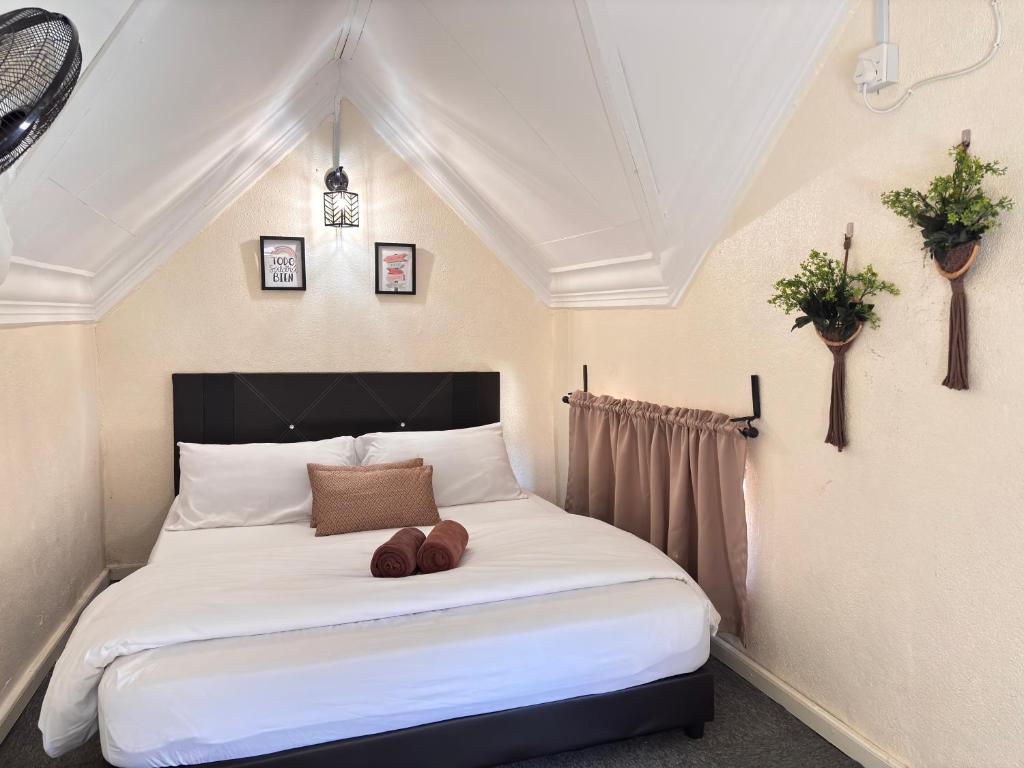 a bedroom with a white bed with two balls on it at Abe.Cottage 2 in Kampung Kuala Besut