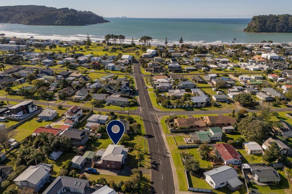 an aerial view of a suburb with a blue marker at Williamson Getaway - Top Whangamata Location in Whangamata