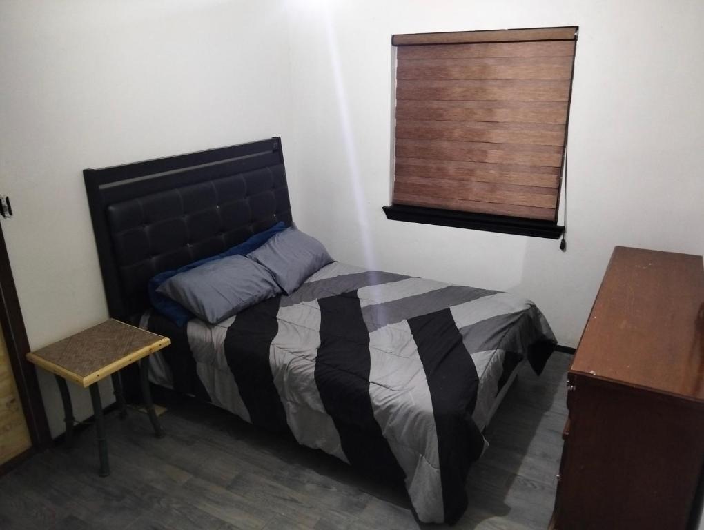 a small bedroom with a bed and a window at Casa amueblada in Manuel F. Martínez
