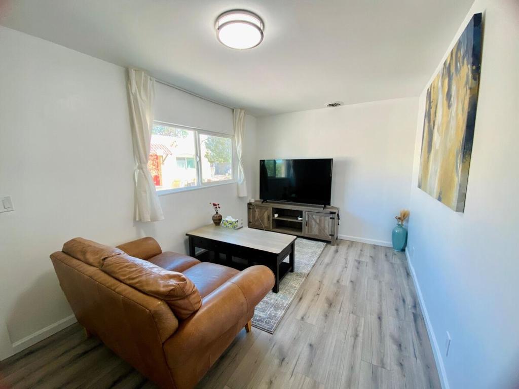 a living room with a couch and a flat screen tv at Private Pet-Friendly Casita in Phoenix