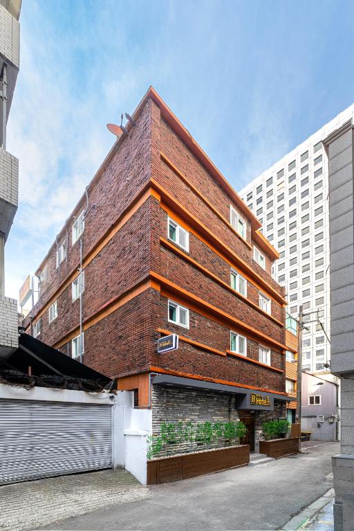 a red brick building with aww at BigBoxStay Myeongdong in Seoul