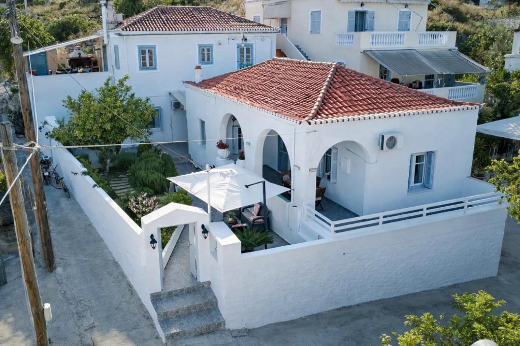 an aerial view of a white house with a red roof at Aroura Homes Spetses 3BR 2BA in Spetses