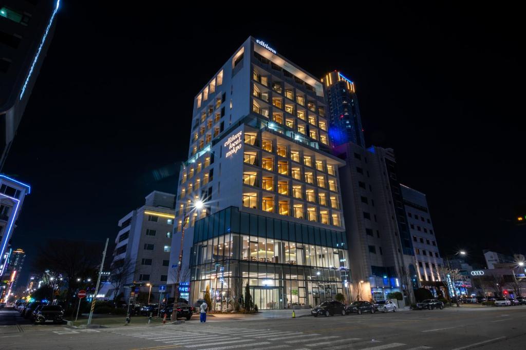 a tall building with many windows at night at Hotel Editions Mokpo in Mokpo