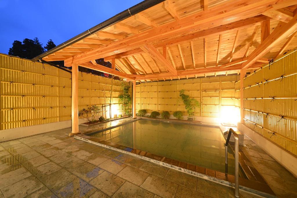 a swimming pool under a wooden pergola at Nikko Station Hotel Classic in Nikko