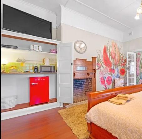 a bedroom with a bed and a tv on the wall at Bank-sia accommodation in Mount Barker