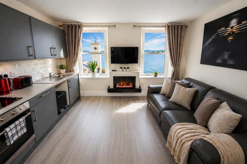 a living room with a couch and a fireplace at Unit 5 Stunning Oceanview Apartment in Cobh
