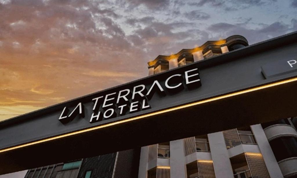 a sign for a hotel in front of a building at Pohang Hotel La Terrace in Pohang