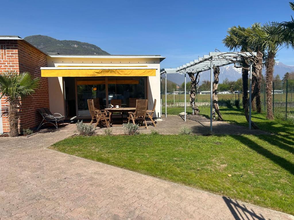 a patio with a table and a gazebo at Casa Fee in Gravedona