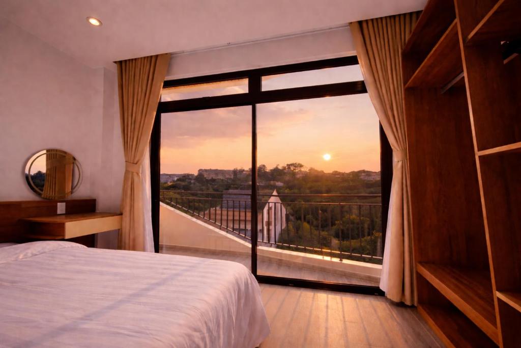 a bedroom with a large window with a view at The SunHill Dalat in Ấp Ða Lợi