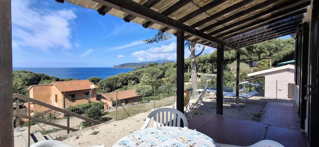 a view of the ocean from the porch of a house at Villa Oleandro in Capoliveri