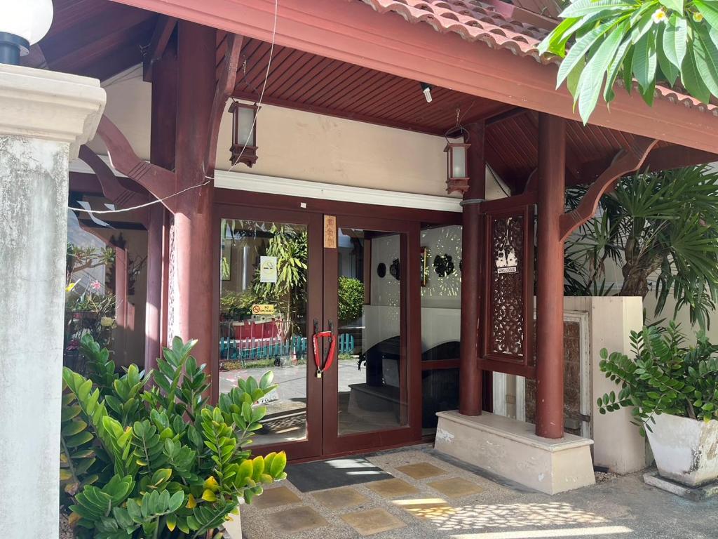 an entry to a house with a glass door at Basic Simple Family 3 Bedroom for 4 Person in Nathon Bay