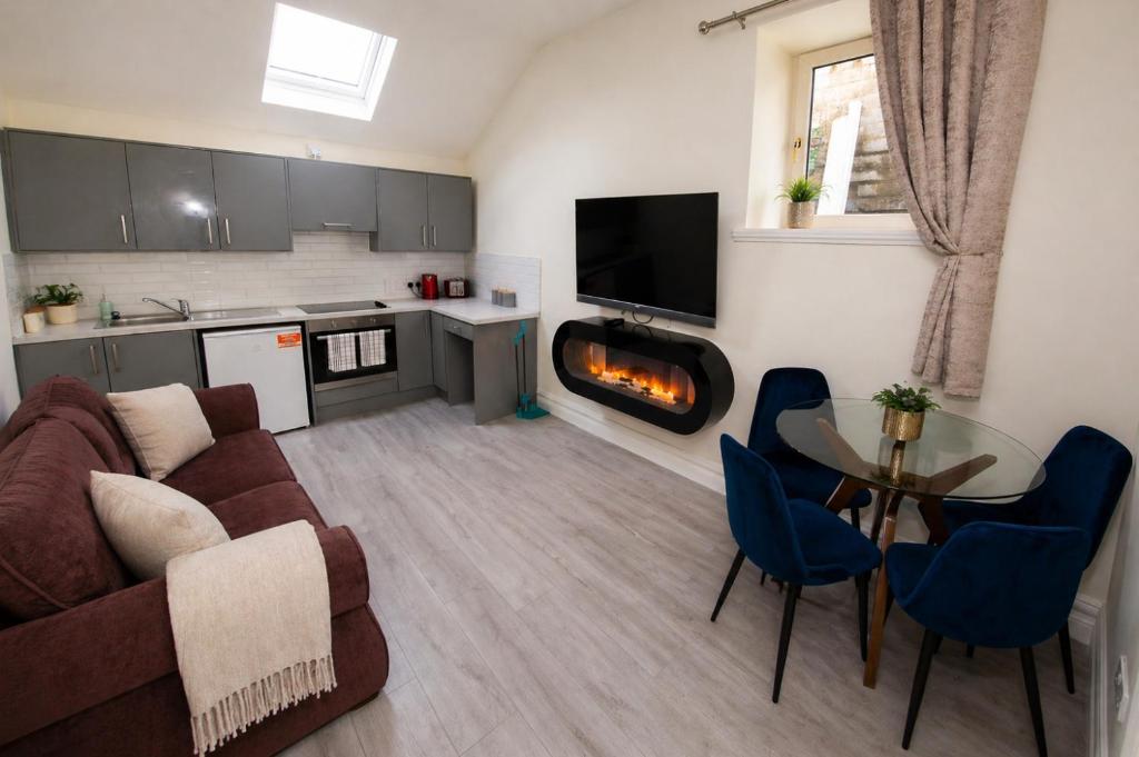 a living room with a couch and a fireplace at Unit 4 Tranquil Harbourside Retreat- Central Location in Cobh